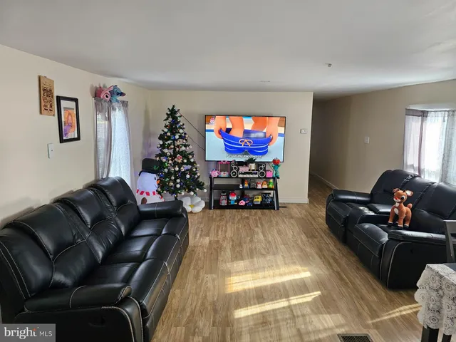 a living room with furniture a couch and a flat screen tv