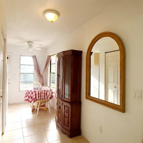 a kitchen with stainless steel appliances granite countertop a refrigerator a stove a sink and a white cabinets