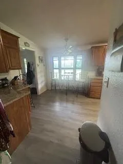 a view of a kitchen with furniture and a fan