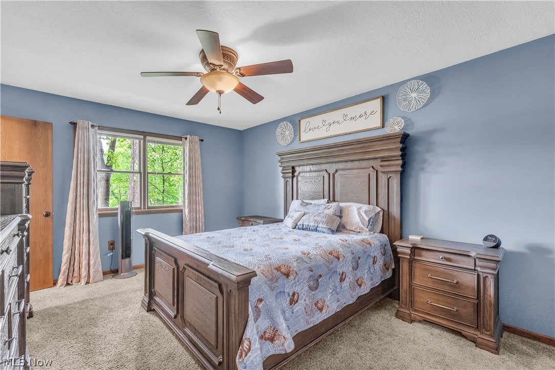408 River Road Canal Fulton, OH 44614 - Photo 21 of 42 Carpeted room with a ceiling fan, light blue walls, and a window with wood trim