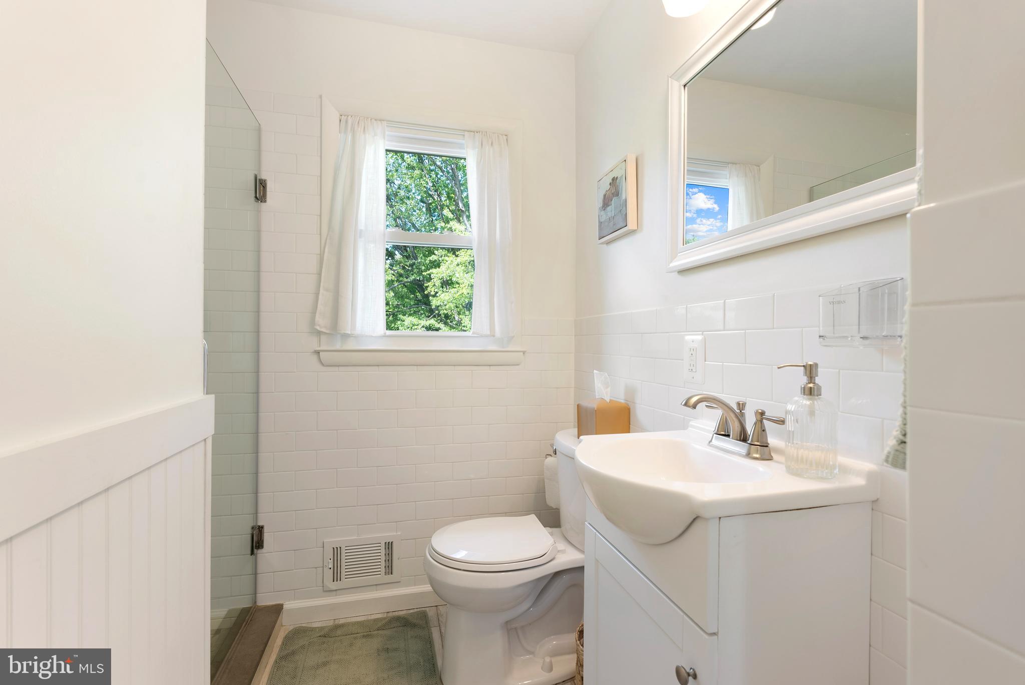 6222 Groveland Road Linthicum Heights, MD 21090 - Photo 18 of 40 a bathroom with a sink toilet and a mirror