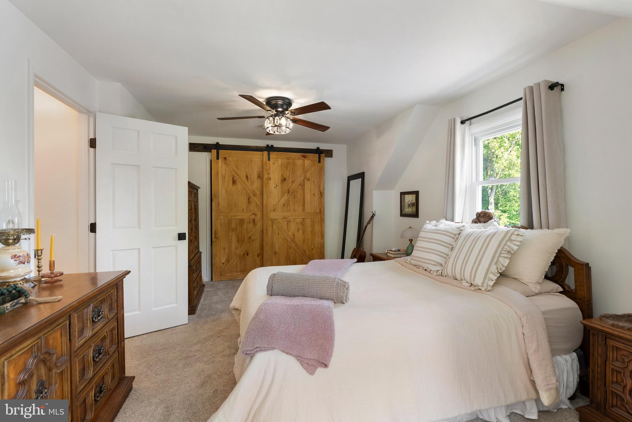 6222 Groveland Road Linthicum Heights, MD 21090 - Photo 23 of 40 a bedroom with a large bed and a chandelier