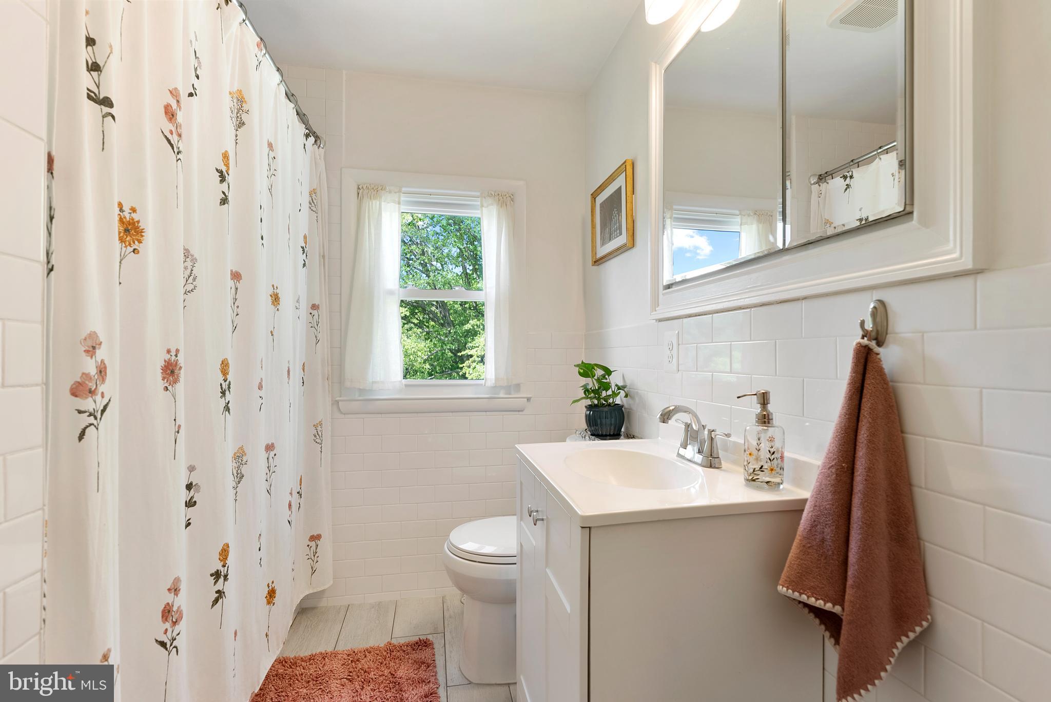 6222 Groveland Road Linthicum Heights, MD 21090 - Photo 24 of 40 a bathroom with a sink and mirror with toilet