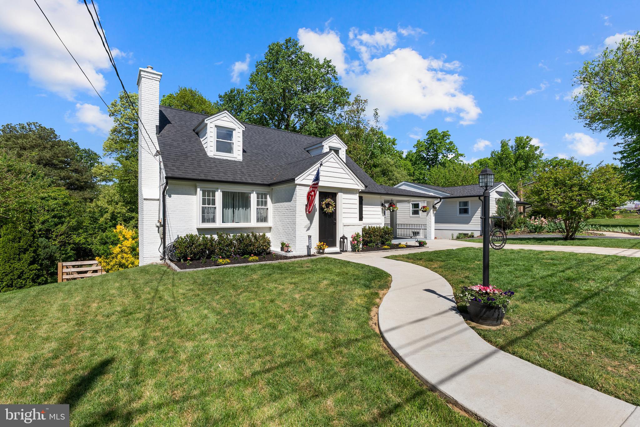 6222 Groveland Road Linthicum Heights, MD 21090 - Photo 3 of 40 a front view of a house with a yard table and chairs