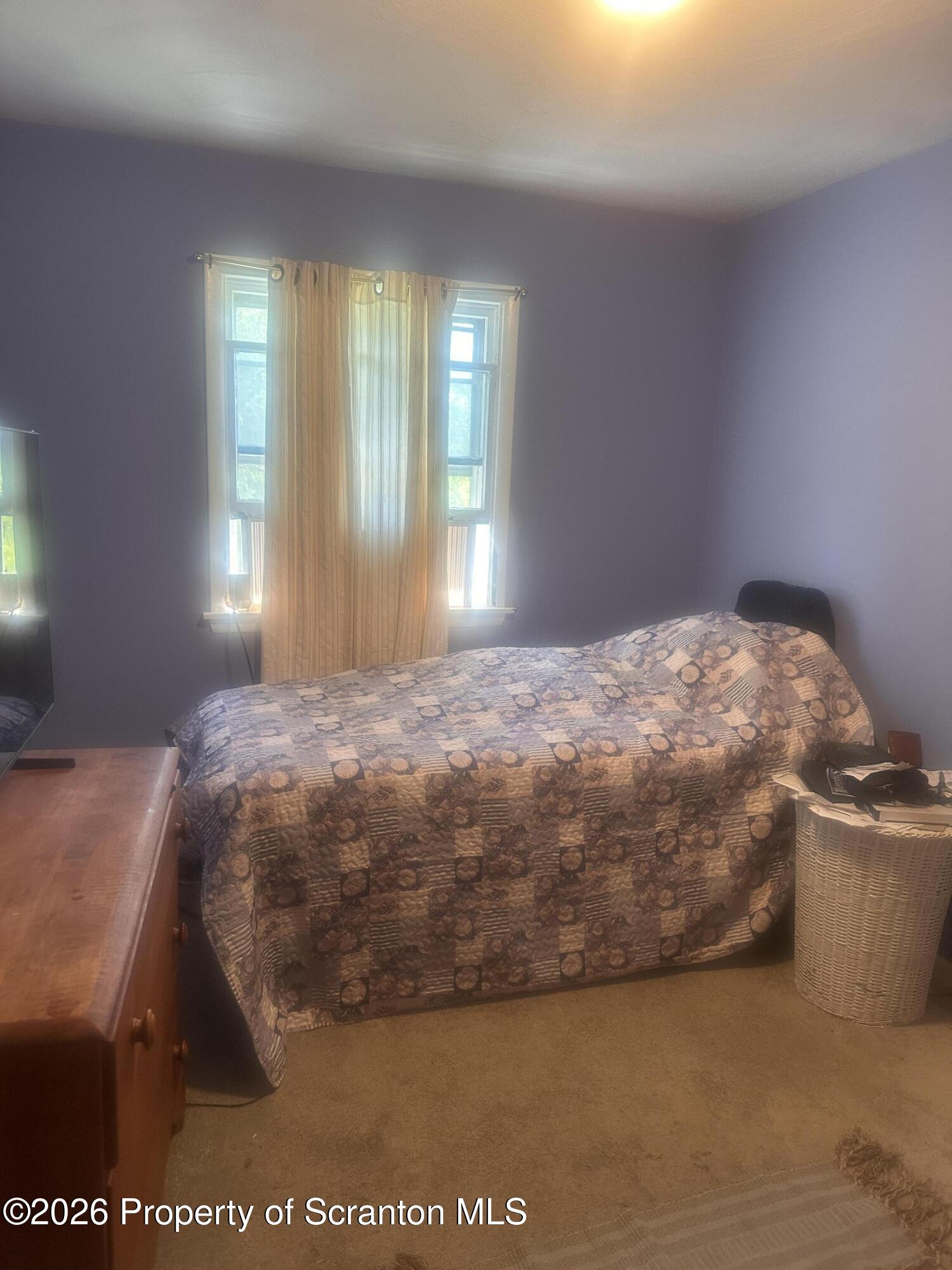 107 Keystone Hls Road, Unit 405 Factoryville, PA 18419 - Photo 25 of 27 a bedroom with a bed and window