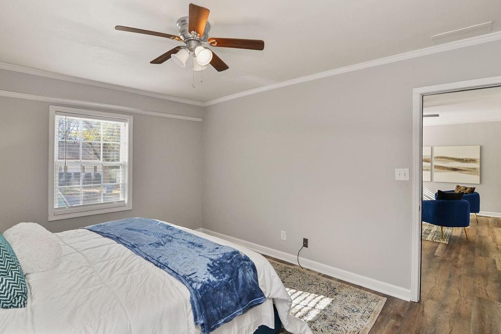 1917 Spring Avenue Atlanta, GA 30344 - Photo 12 of 22 a bedroom with a bed and a chandelier