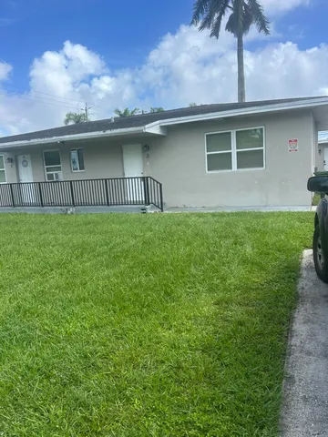 a view of a house with a yard and a large window