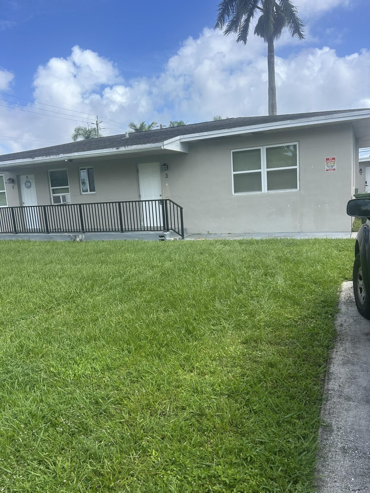 a view of a house with a yard and a large window