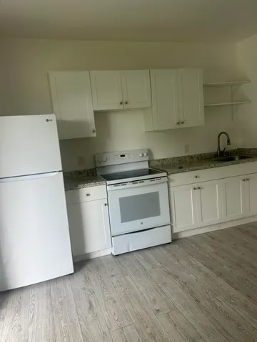 a kitchen with a sink a stove and refrigerator