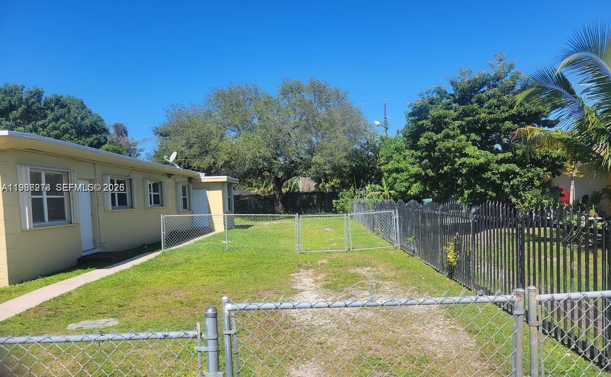 751 Northwest 96th Street, Unit 751 Miami, FL 33150 - Photo 11 of 11 a view of a house with a yard