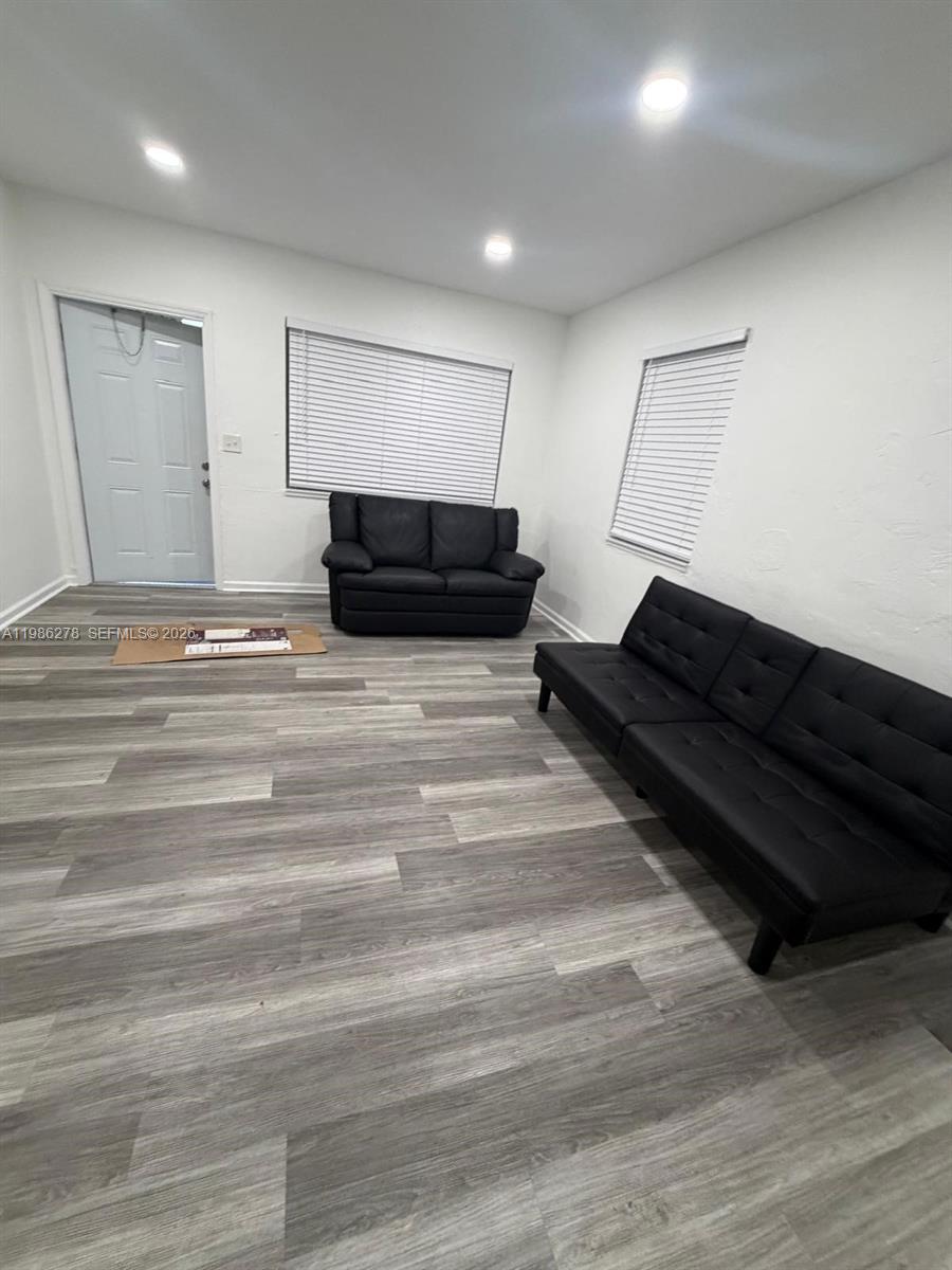 751 Northwest 96th Street, Unit 751 Miami, FL 33150 - Photo 2 of 11 a living room with a couch and a wooden floor