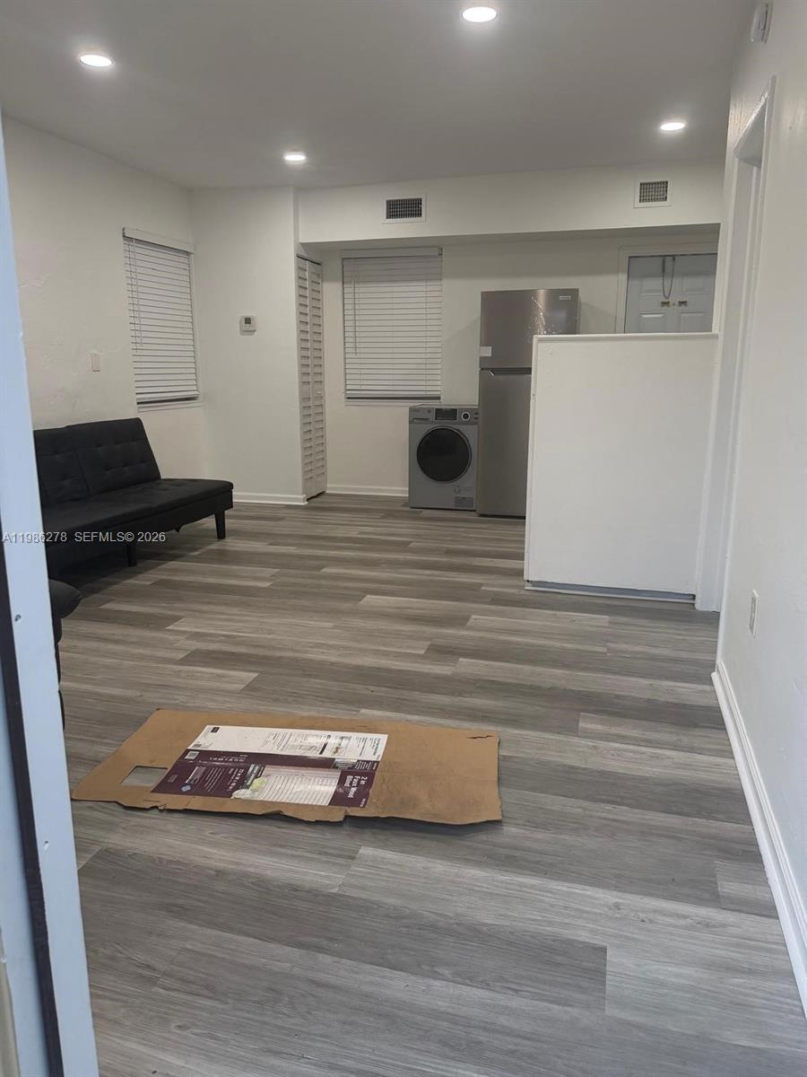 751 Northwest 96th Street, Unit 751 Miami, FL 33150 - Photo 3 of 11 a view of hallway with wooden floor