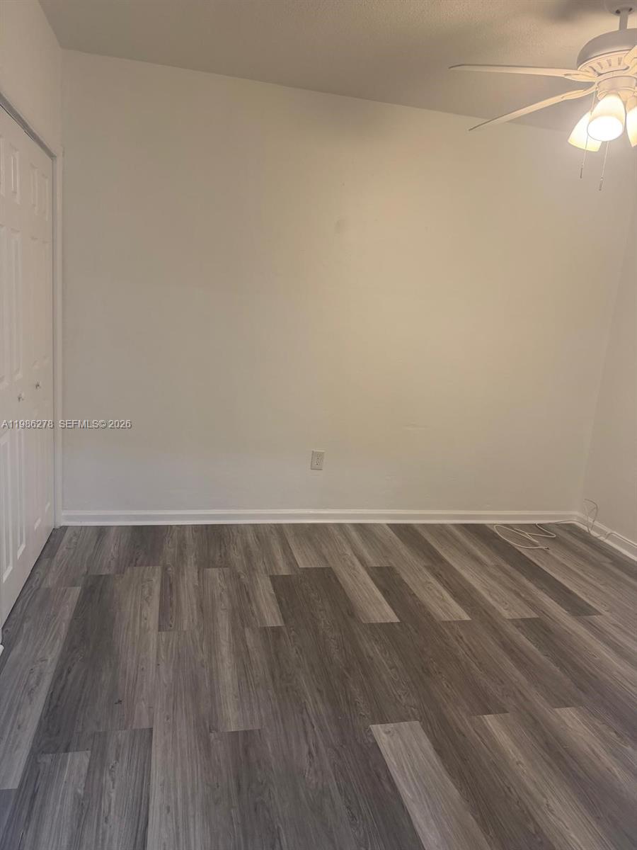 751 Northwest 96th Street, Unit 751 Miami, FL 33150 - Photo 4 of 11 a view of an empty room and wooden floor