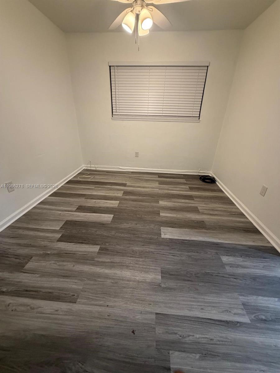 751 Northwest 96th Street, Unit 751 Miami, FL 33150 - Photo 5 of 11 a view of a room with wooden floor