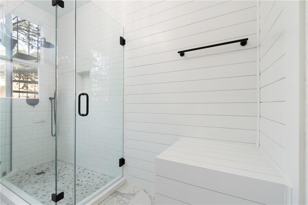 3210 Hampton Road, Unit A B C Austin, TX 78705 - Photo 34 of 42 Glass-enclosed shower featuring subway tile, pebble flooring, and black hardware