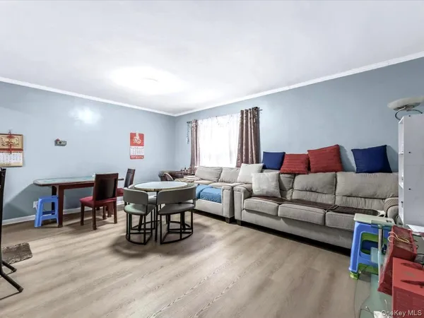 a living room with furniture a dining table and a piano next to a window