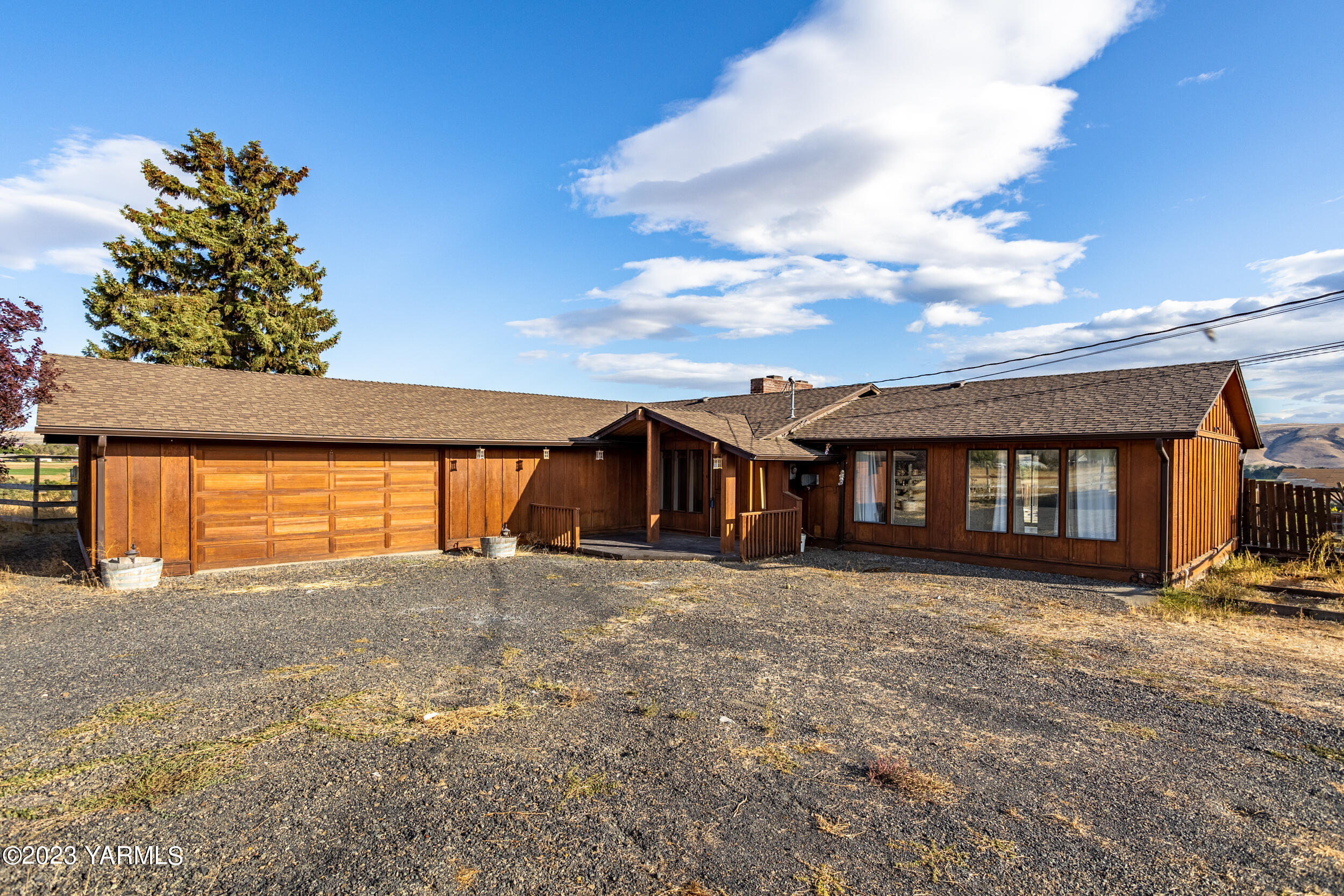 125 Johnson Road Selah, WA 98942 - Photo 2 of 36 a big house with large windows and a yard