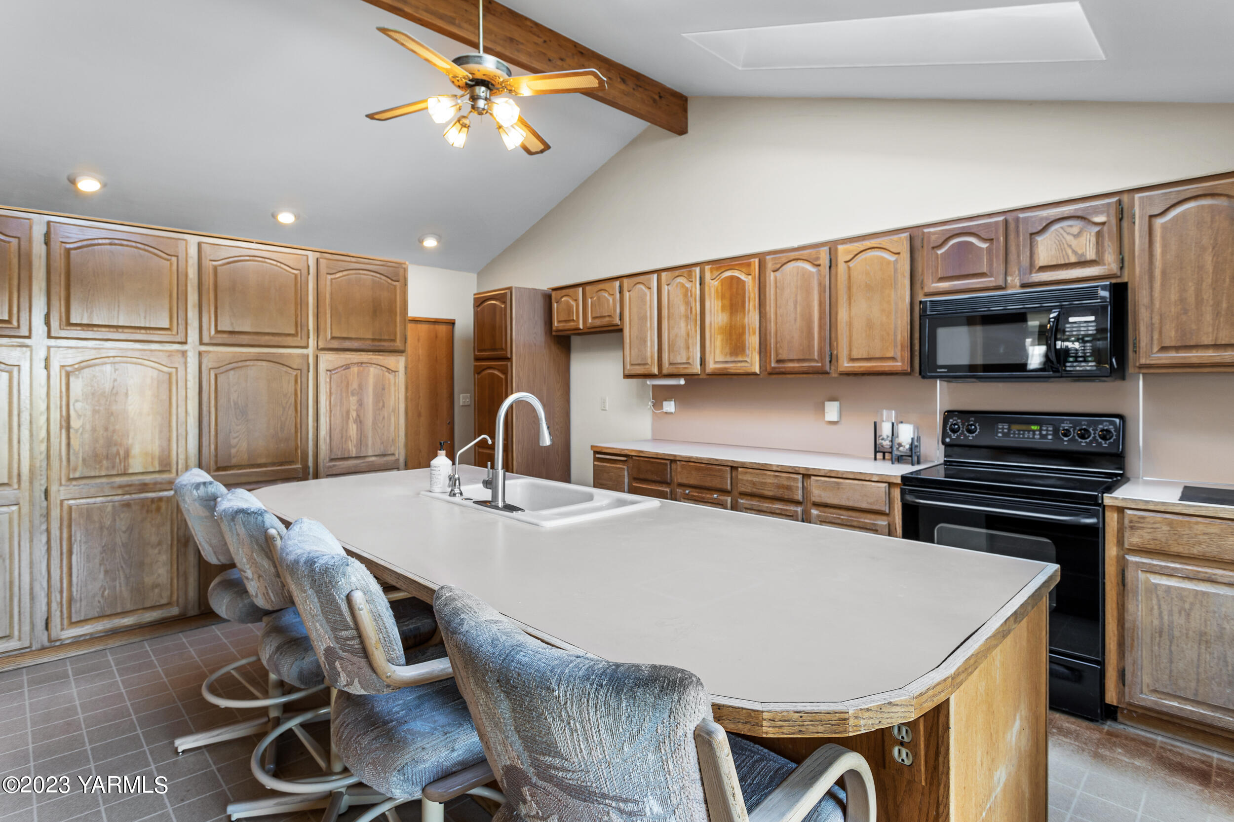 125 Johnson Road Selah, WA 98942 - Photo 9 of 36 a kitchen with stainless steel appliances granite countertop a stove a refrigerator a sink a dining table and chairs with wooden floor