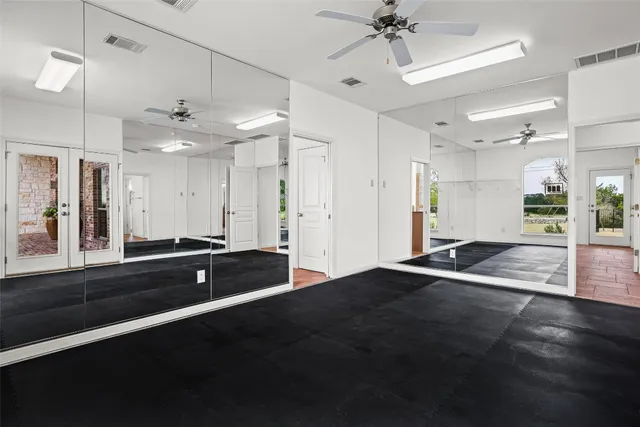 an aerial view of a house with a yard and parking