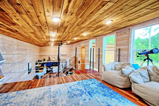 a living room filled with furniture and a chandelier
