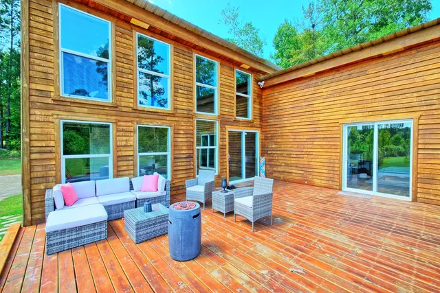 a balcony with furniture and wooden floor