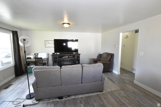 290 West 600 North Logan, UT 84321 - Photo 9 of 45 Spacious interior room featuring wood-finish flooring, light-toned walls, a large window, and an overhead light fixture
