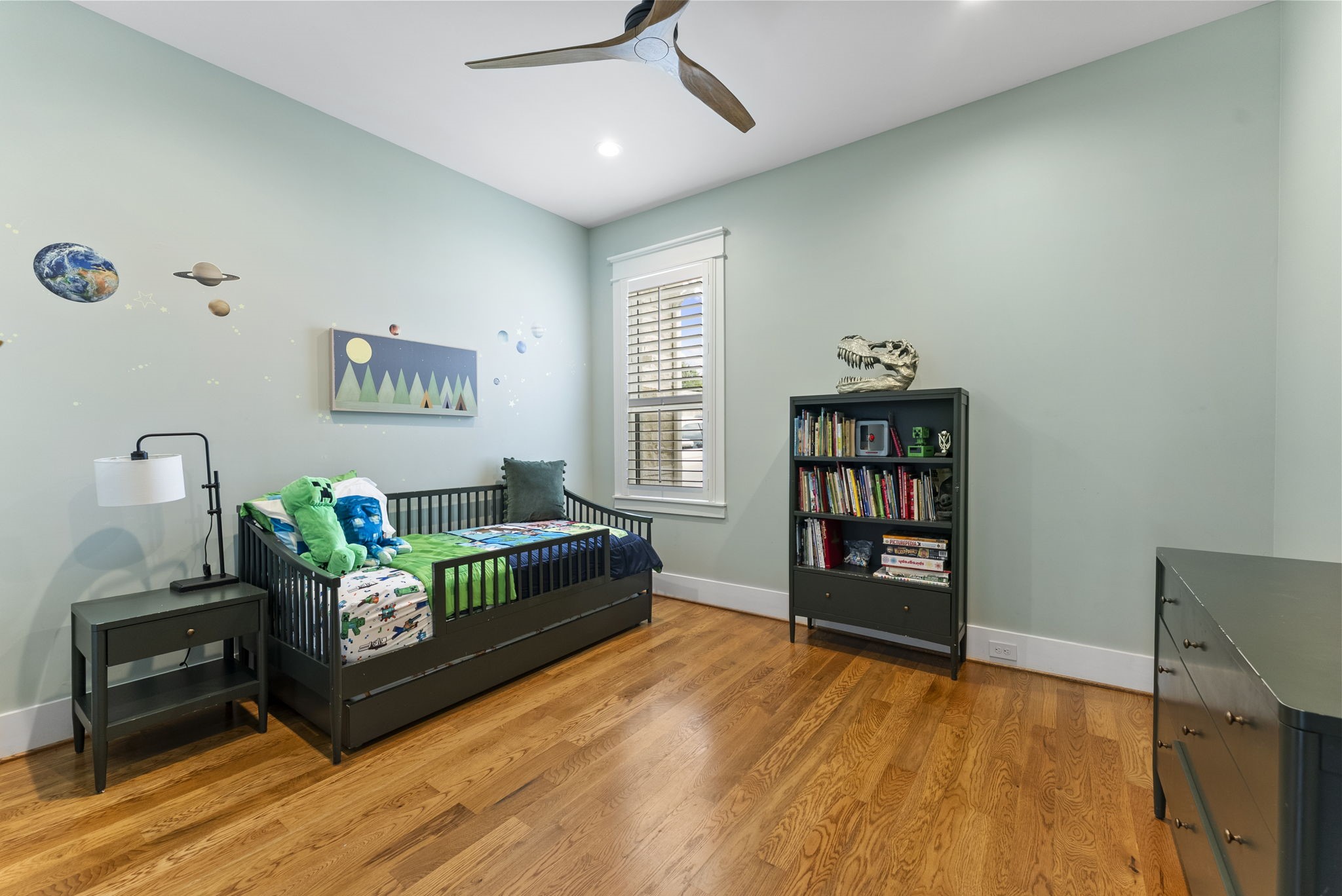 14019 Beartooth Bend Trail Conroe, TX 77384 - Photo 22 of 28 Light-filled secondary bedroom with hardwood floors, plantation shutters, and generous space for everyday living.