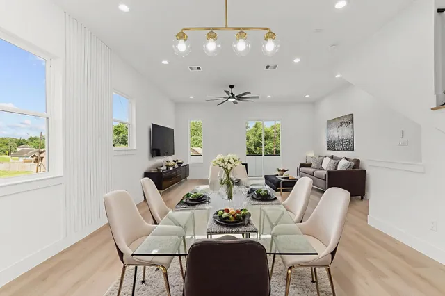 a living room with furniture a chandelier and a flat screen tv