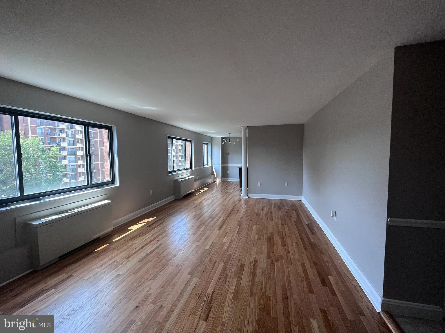 1200 South Arlington Road, Unit 504 Arlington, VA 22209 - Photo 1 of 20 a view of empty room with window and wooden floor