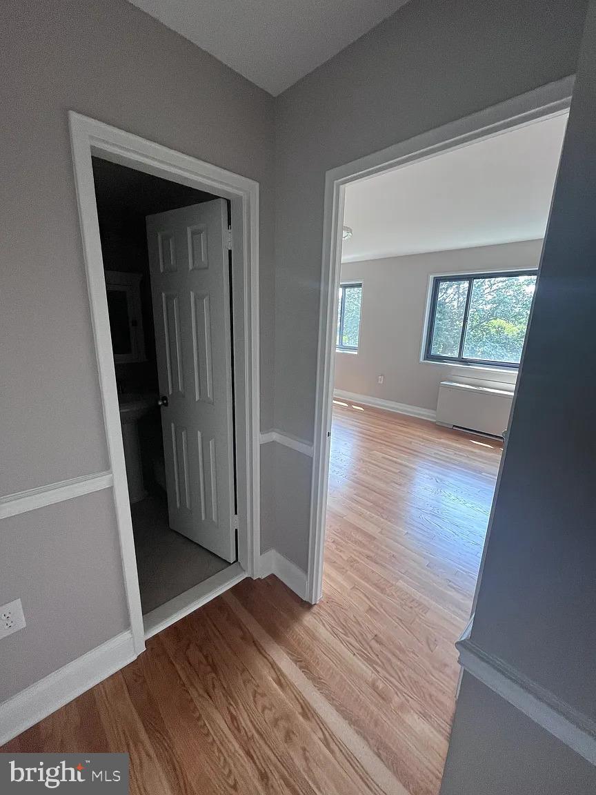 1200 South Arlington Road, Unit 504 Arlington, VA 22209 - Photo 12 of 20 an empty room with wooden floor and a window