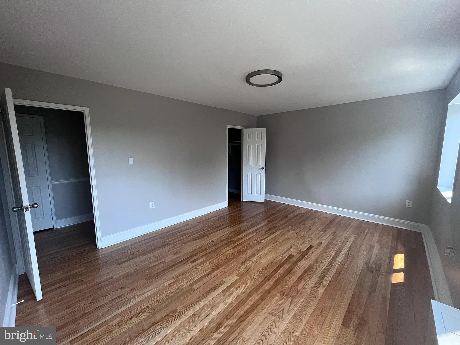 1200 South Arlington Road, Unit 504 Arlington, VA 22209 - Photo 3 of 20 an empty room with wooden floor and entrance