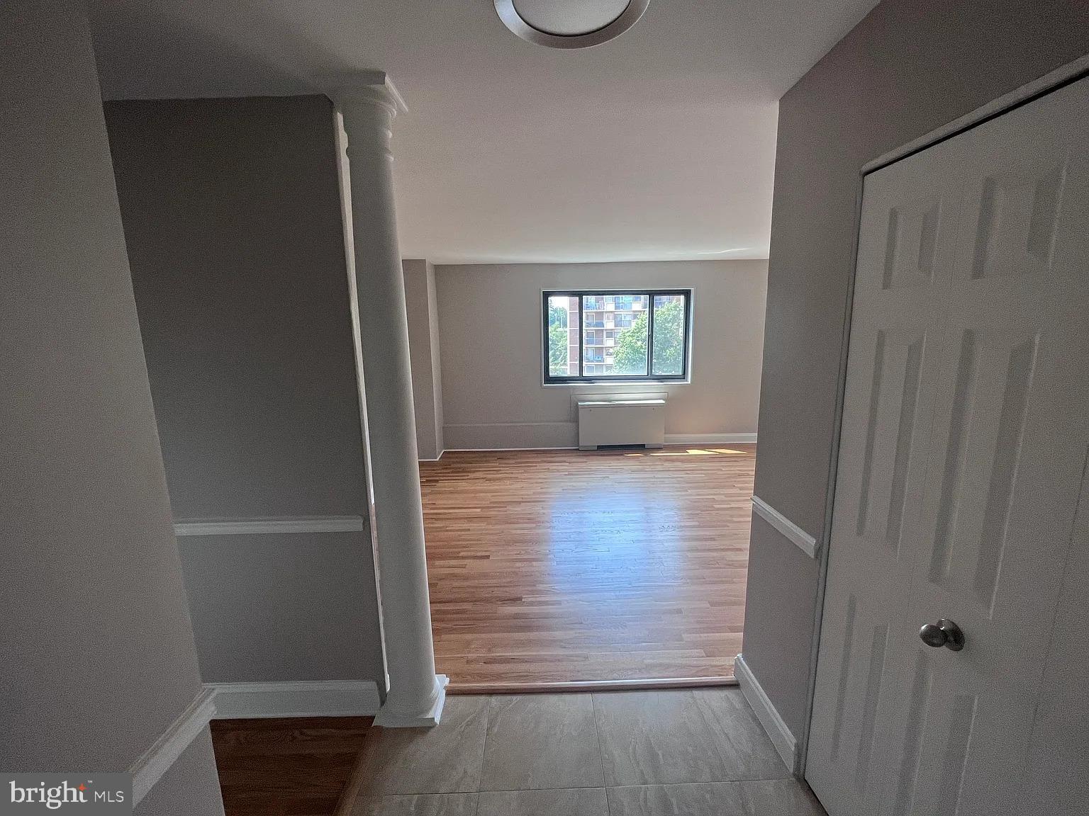 1200 South Arlington Road, Unit 504 Arlington, VA 22209 - Photo 7 of 20 an empty room with wooden floor closet and windows