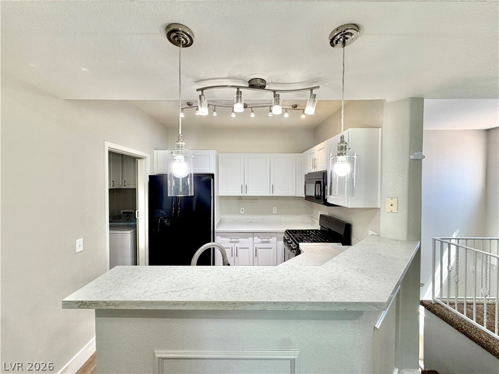 8555 West Russell Road, Unit 2018 Las Vegas, NV 89113 - Photo 1 of 23 A well-appointed kitchen features a practical breakfast bar and contemporary appliances.