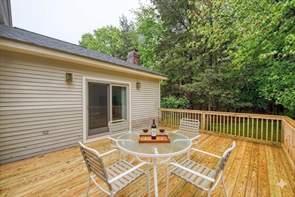 7 Tisdale Road Sharon, MA 02067 - Photo 33 of 37 a view of a patio with a table and chairs and wooden floor