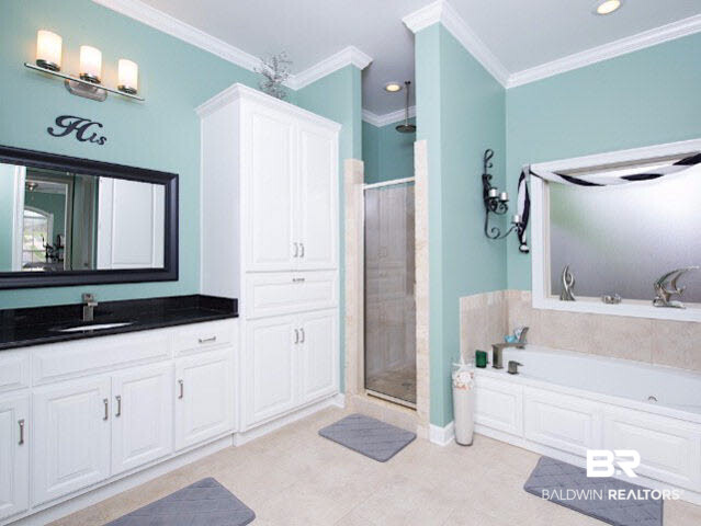 7814 Balin Drive Daphne, AL 36527 - Photo 13 of 26 This bathroom features his and her vanities, separate tub and shower, as well as plenty of storage.