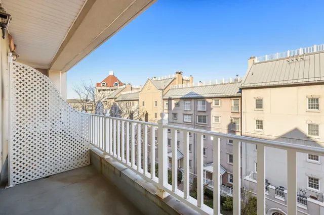 a view of a balcony with yard
