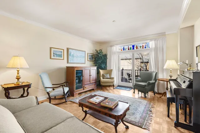 a living room with furniture a rug and a large window