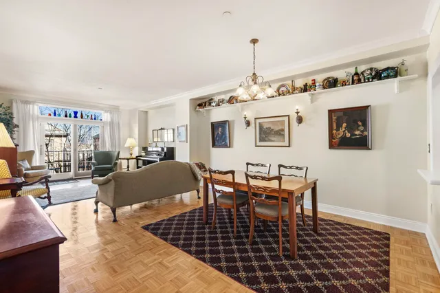 a living room with furniture a rug and a table