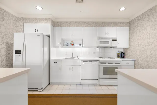 a kitchen with cabinets appliances and a counter