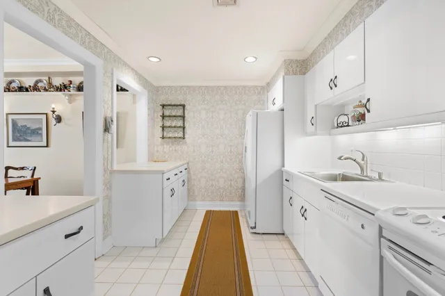 a spacious bathroom with a double vanity sink mirror and bathtub