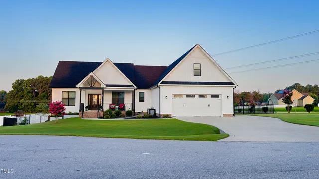 a view of house with yard and green space