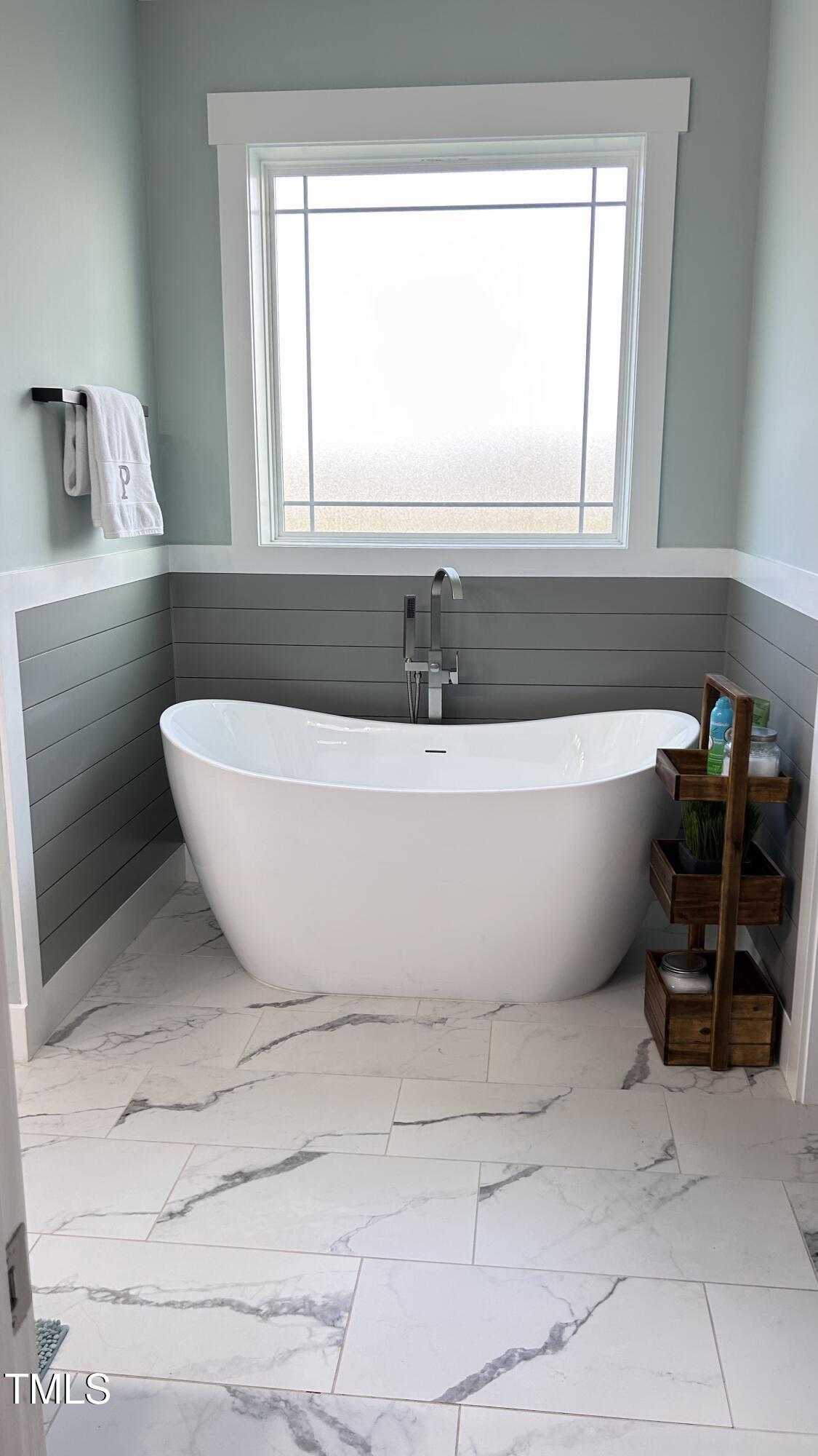 18 Pawnee Place Willow Spring, NC 27592 - Photo 19 of 35 a white bath tub sitting next to a window