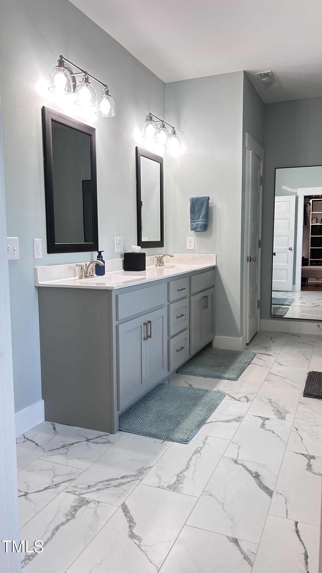 18 Pawnee Place Willow Spring, NC 27592 - Photo 20 of 35 a spacious bathroom with a sink double vanity and a mirror