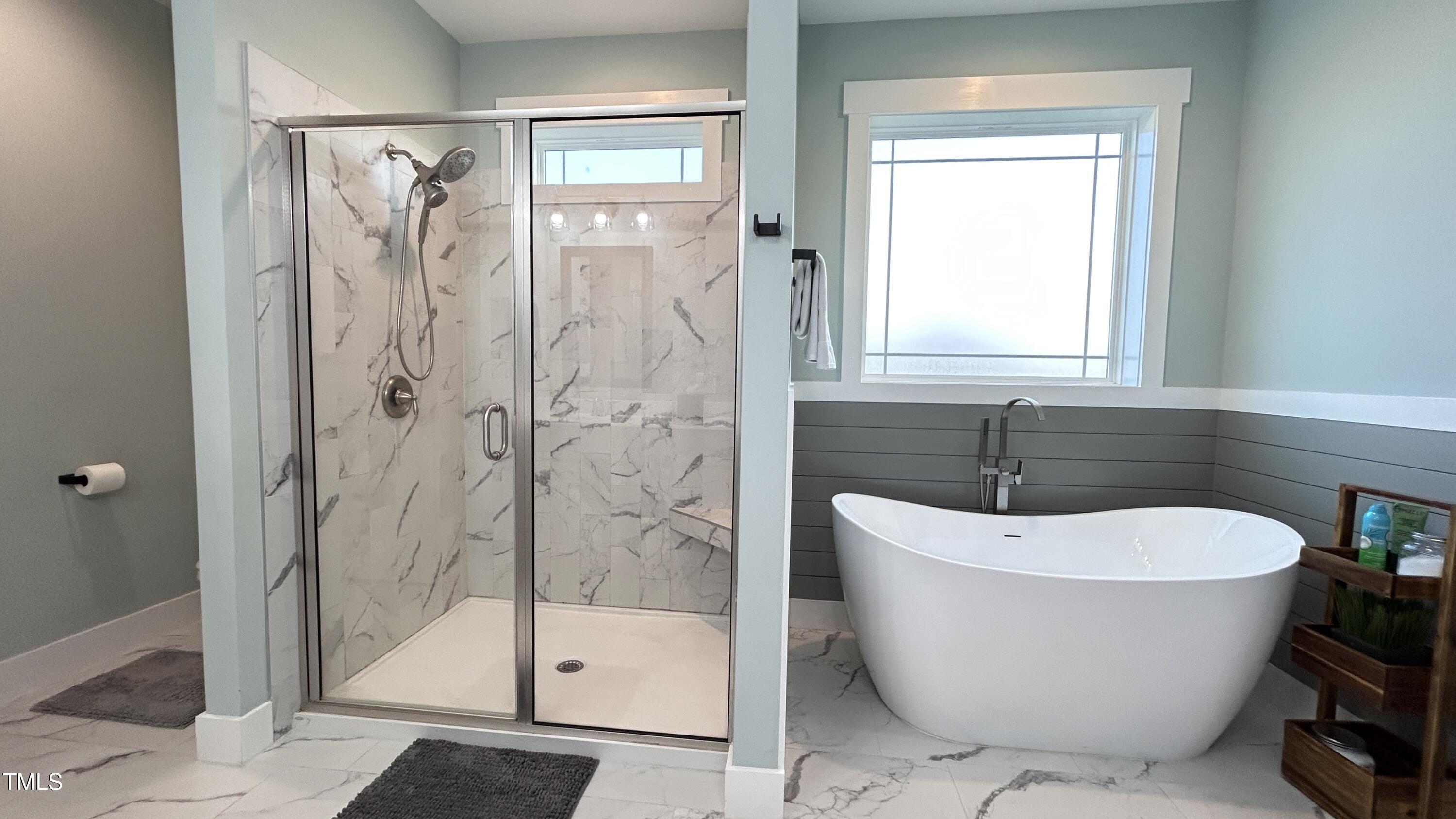 18 Pawnee Place Willow Spring, NC 27592 - Photo 22 of 35 a white bath tub sitting next to a shower