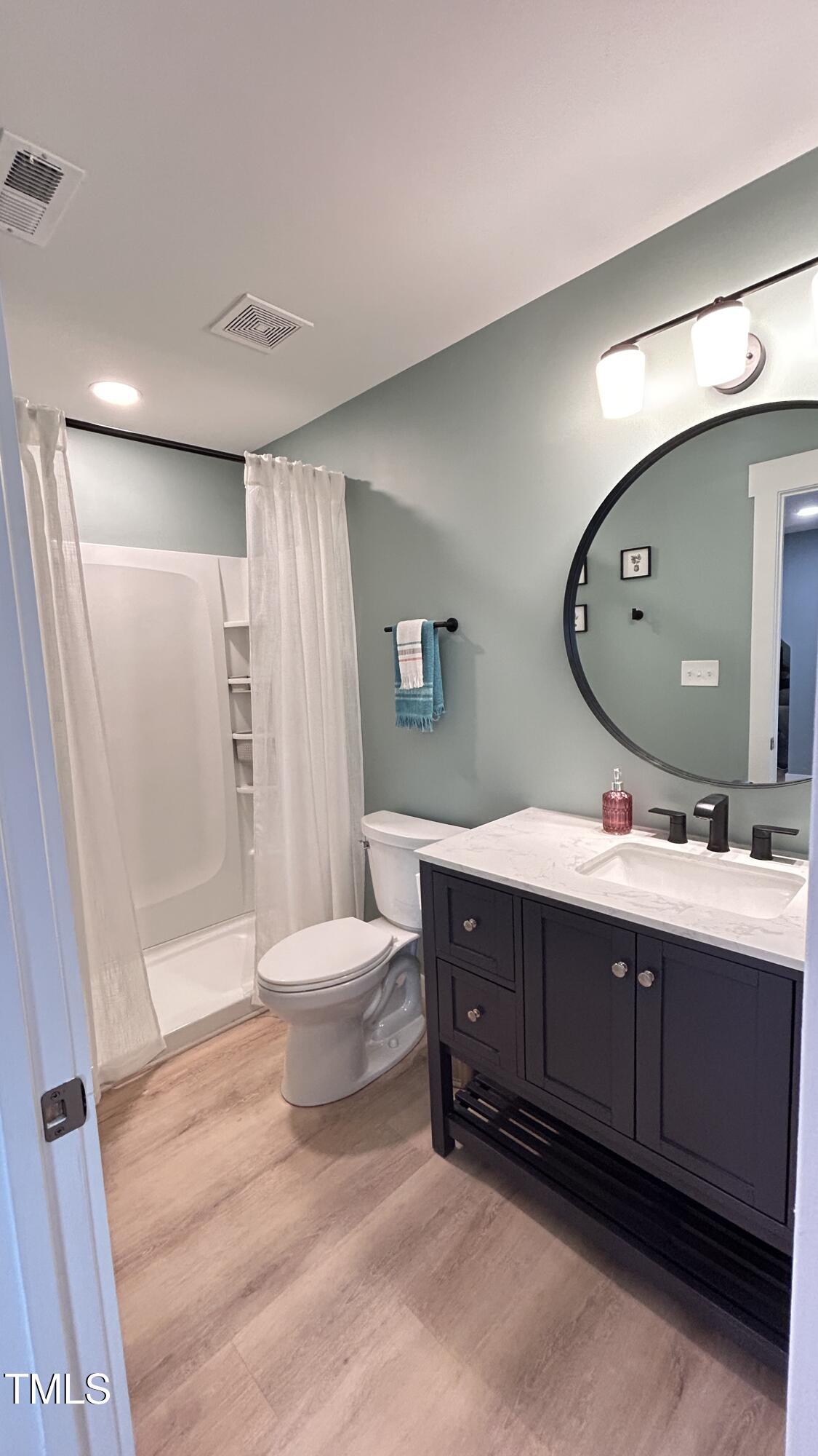 18 Pawnee Place Willow Spring, NC 27592 - Photo 24 of 35 a bathroom with a sink mirror vanity and toilet