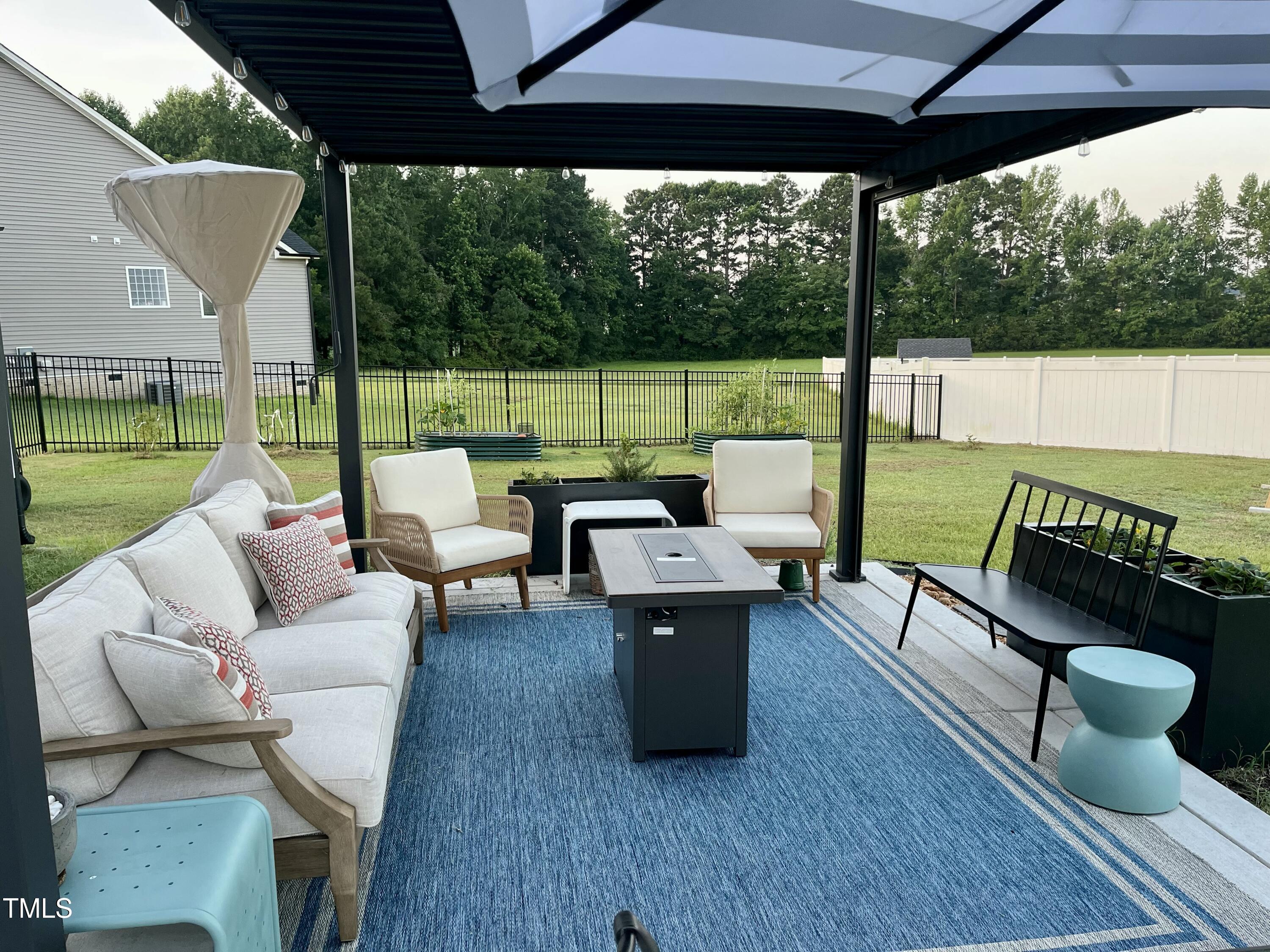 18 Pawnee Place Willow Spring, NC 27592 - Photo 30 of 35 a balcony with couple of chairs and a wooden floor