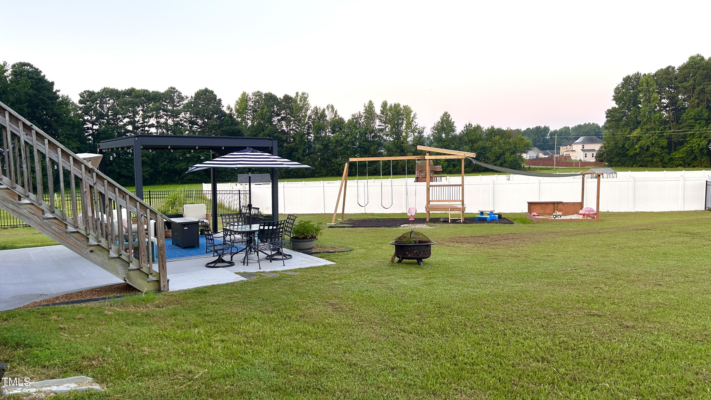 18 Pawnee Place Willow Spring, NC 27592 - Photo 32 of 35 a view of a house with backyard and sitting area