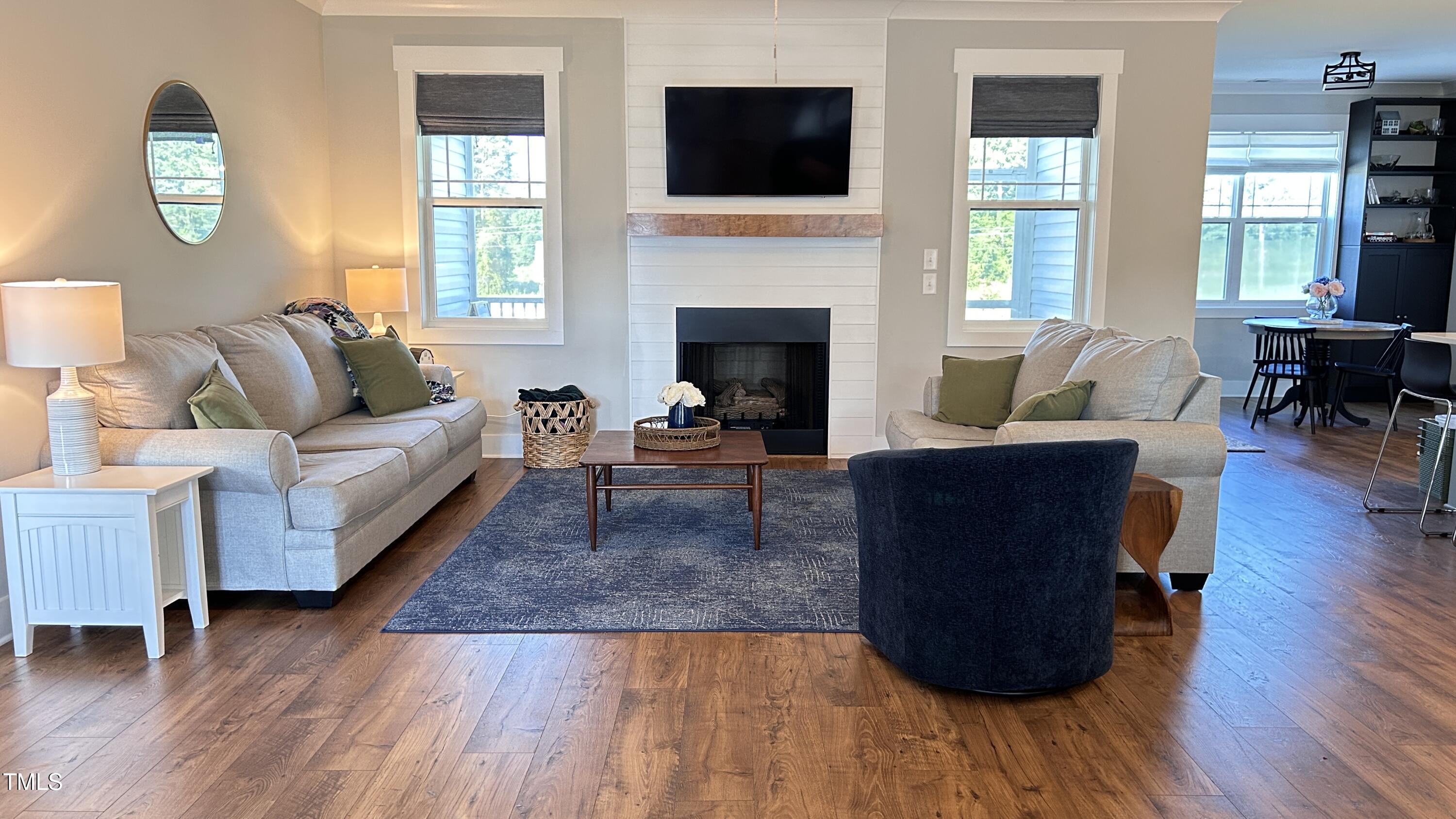 18 Pawnee Place Willow Spring, NC 27592 - Photo 4 of 35 a living room with furniture and a fireplace