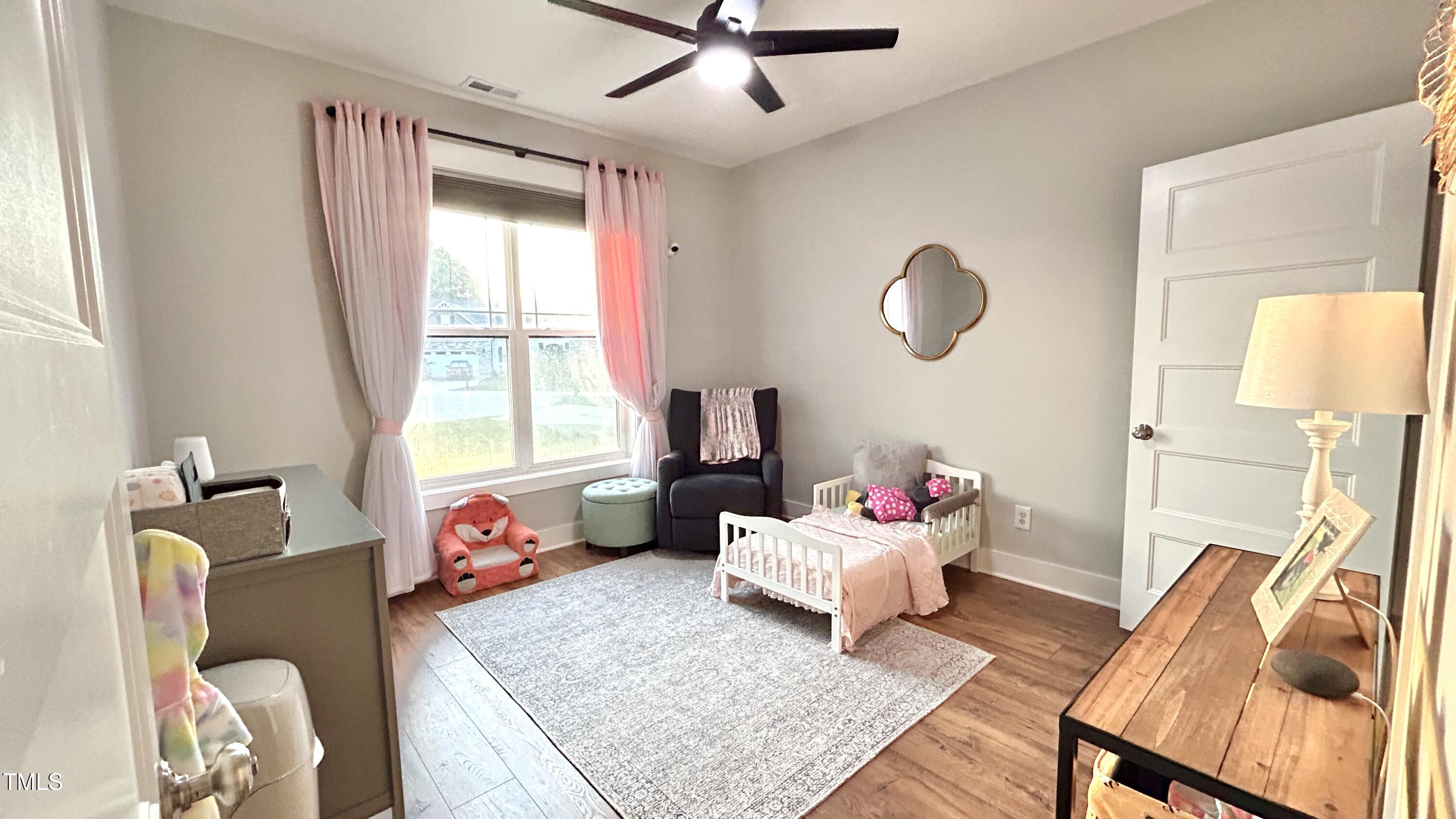 18 Pawnee Place Willow Spring, NC 27592 - Photo 9 of 35 a bedroom with furniture and a window