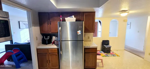 a kitchen with refrigerator a washer and dryer